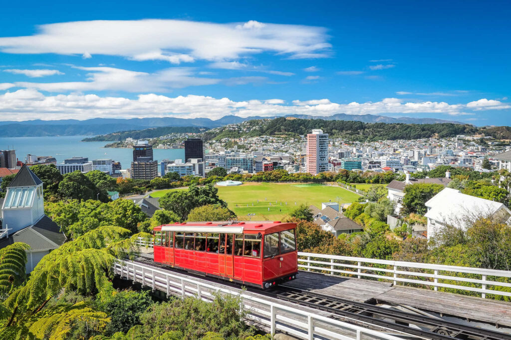 Vibrant Wellington Wallpaper: Red Cable Car & Lush Greenery