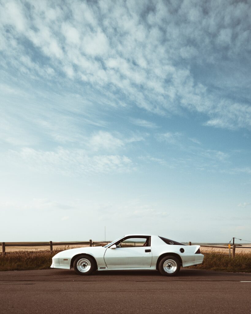 Sleek White Chevrolet Camaro Wallpaper Against a Vast Sky