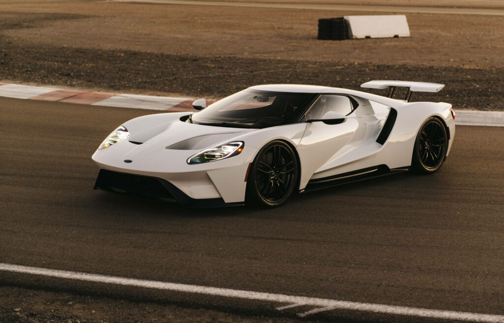 White Ford GT supercar on race track showcasing aerodynamic design and high-performance features Wallpaper