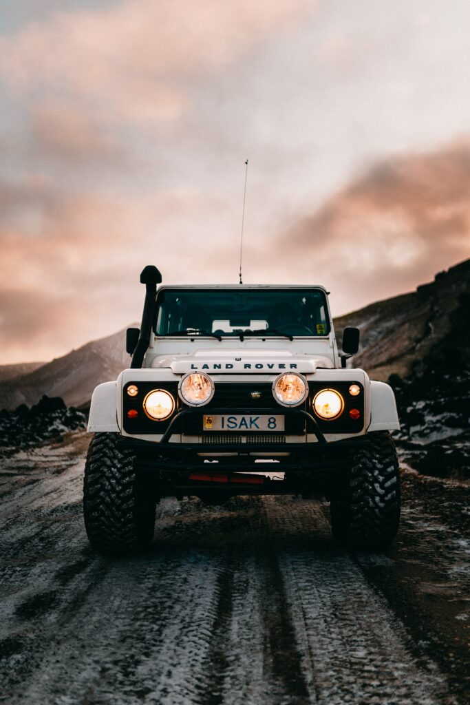 White Land Rover in Scenic Rugged Backdrop - Adventurous Wallpaper