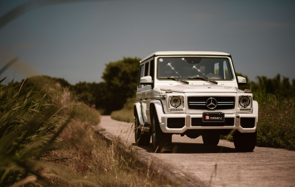 Stunning White Mercedes-Benz G 63 AMG SUV Wallpaper with Natural Backdrop
