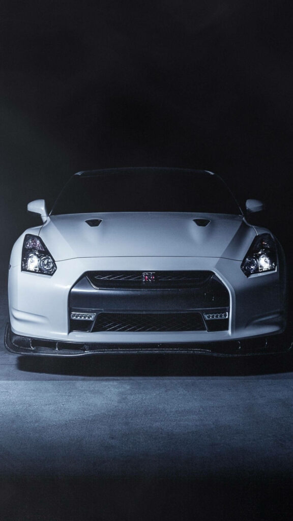 Sleek White Nissan GTR Wallpaper: Aggressive Design on Dark Background