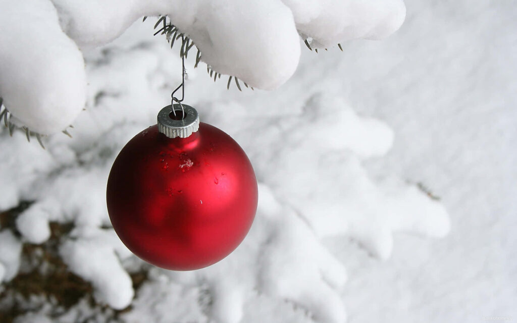 Charming Winter Night: Red Ornament on Snowy Holiday Tree Wallpaper
