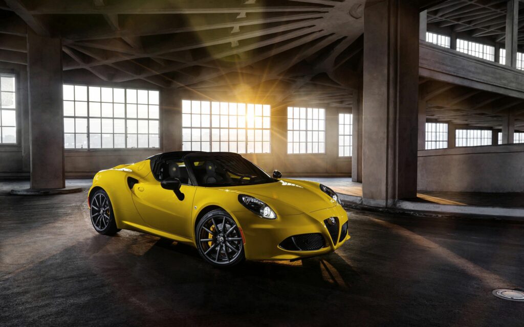 Stunning Yellow Alfa Romeo 4C Spider Wallpaper with Industrial Background