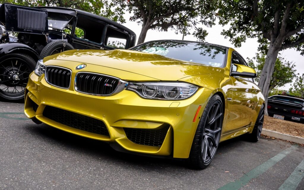 Bold Yellow BMW F82 M4 Wallpaper: Striking Design & Outdoor Setting