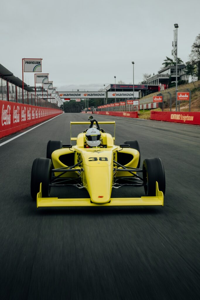 Vibrant Yellow Formula 1 Car on Track: Speed & Precision Wallpaper