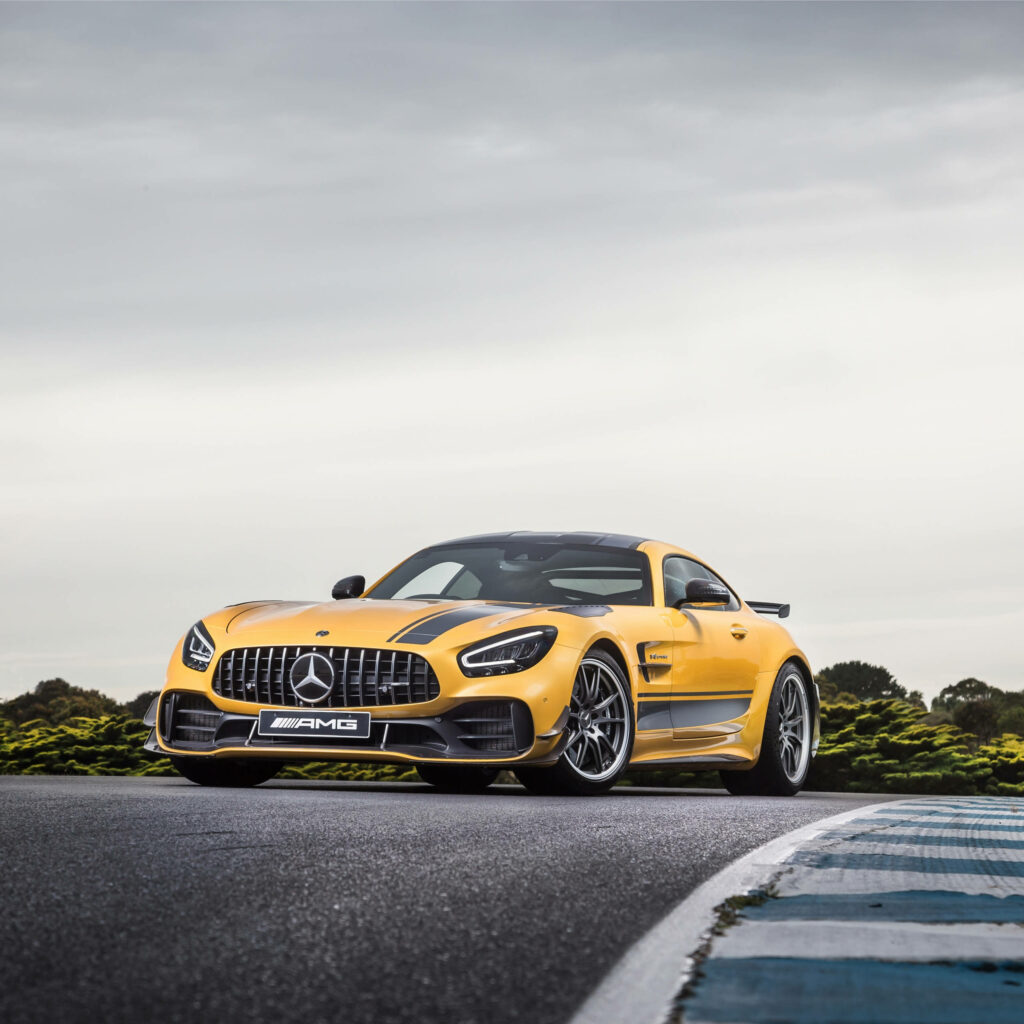 Stunning Yellow Mercedes-Benz AMG Wallpaper on Racetrack Background
