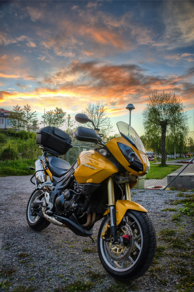 Stunning Yellow Motorcycle Close-Up against Vibrant Sunset Wallpaper