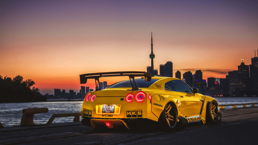 Stunning Nissan GT-R Wallpaper: Sunset Cityscape & Water Edge