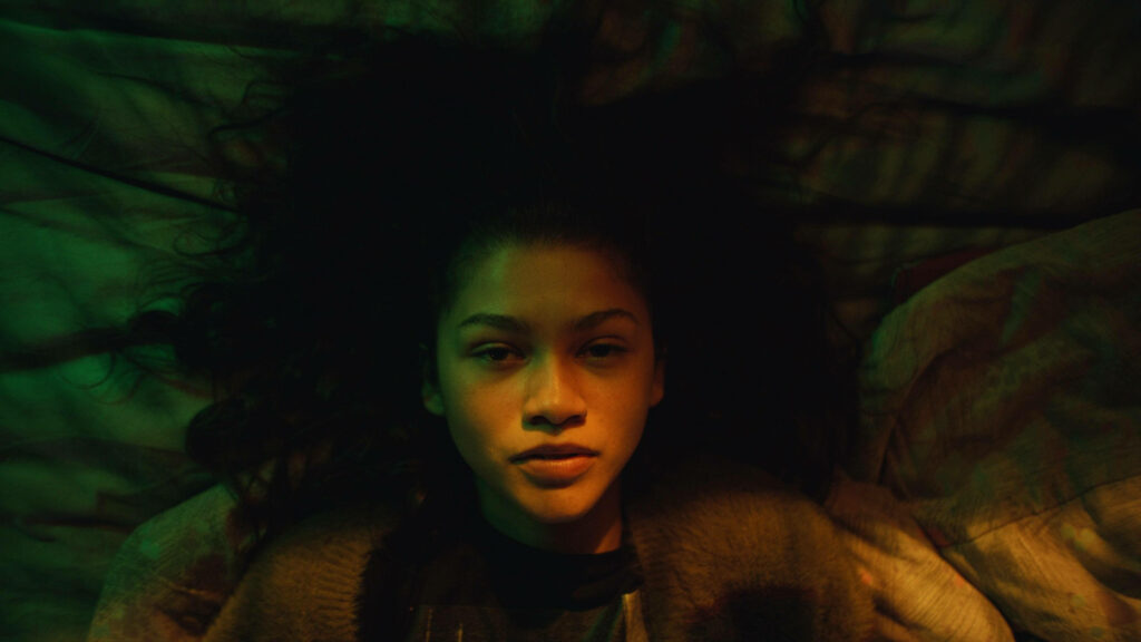 Zendaya as Rue: Striking Flat Lay Wallpaper with Artistic Lighting