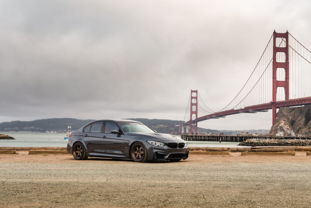 Sleek Black BMW M4 Against Golden Gate Bridge - Stunning Wallpaper