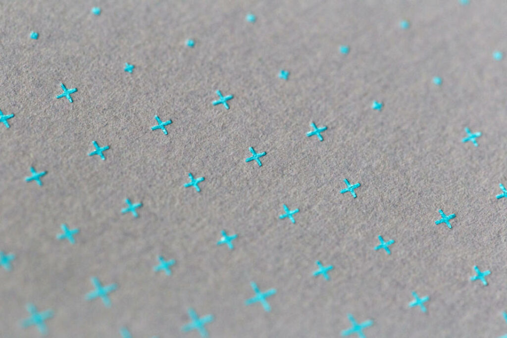 Modern Blue Cross Wallpaper on Textured Gray Background