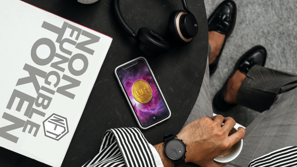 Businessman with headphones watch book Non Fungible Token smartphone NFT coin modern workspace Wallpaper