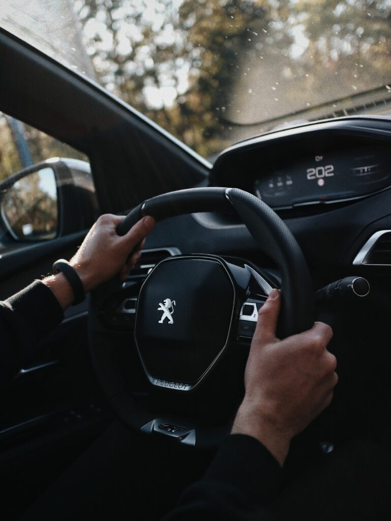Stylish Car Interior: Hands on Steering Wheel & Modern Dashboard Wallpaper