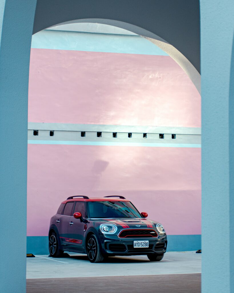 Stylish Car Wallpaper: Sleek Design with Pastel Pink & Blue Background