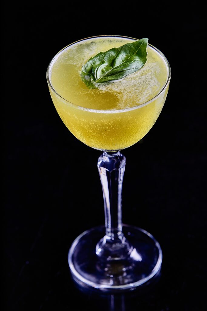 Refreshing Cocktail Wallpaper: Stylish Glass with Basil Leaf