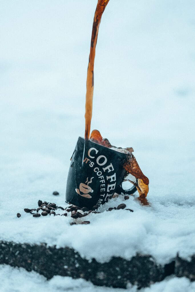Stylish Wallpaper: Coffee Cup Spill on Snow with Coffee Beans
