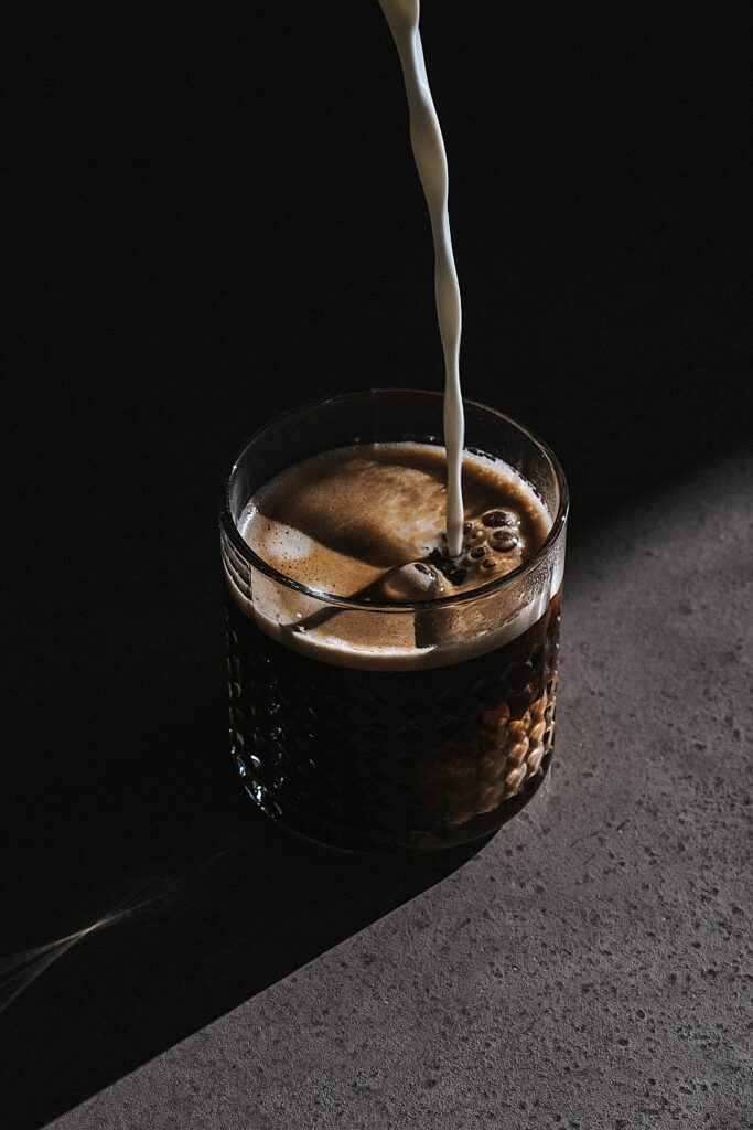 Silky Milk Pours into Dark Coffee - Captivating Wallpaper Background