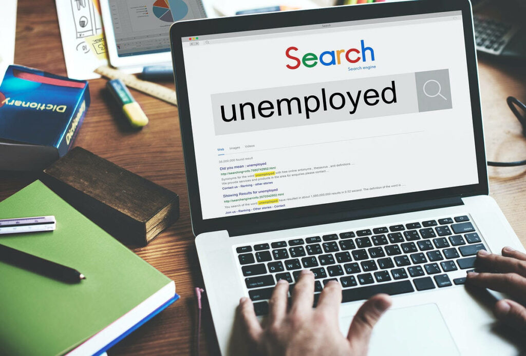 Desk Setup Wallpaper: Exploring Unemployment Research with Laptop