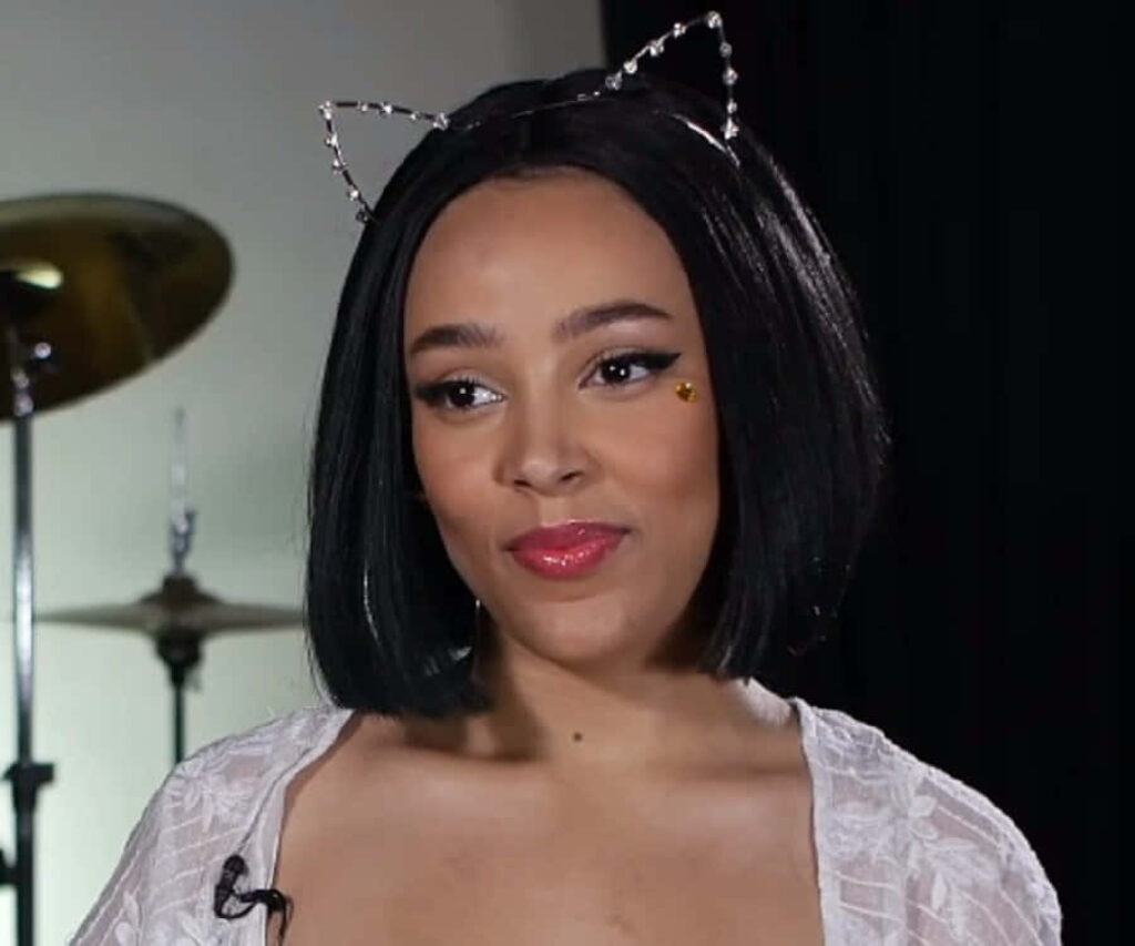 Doja Cat Stylish Wallpaper: Confident Charm with Cat-Ear Accessories