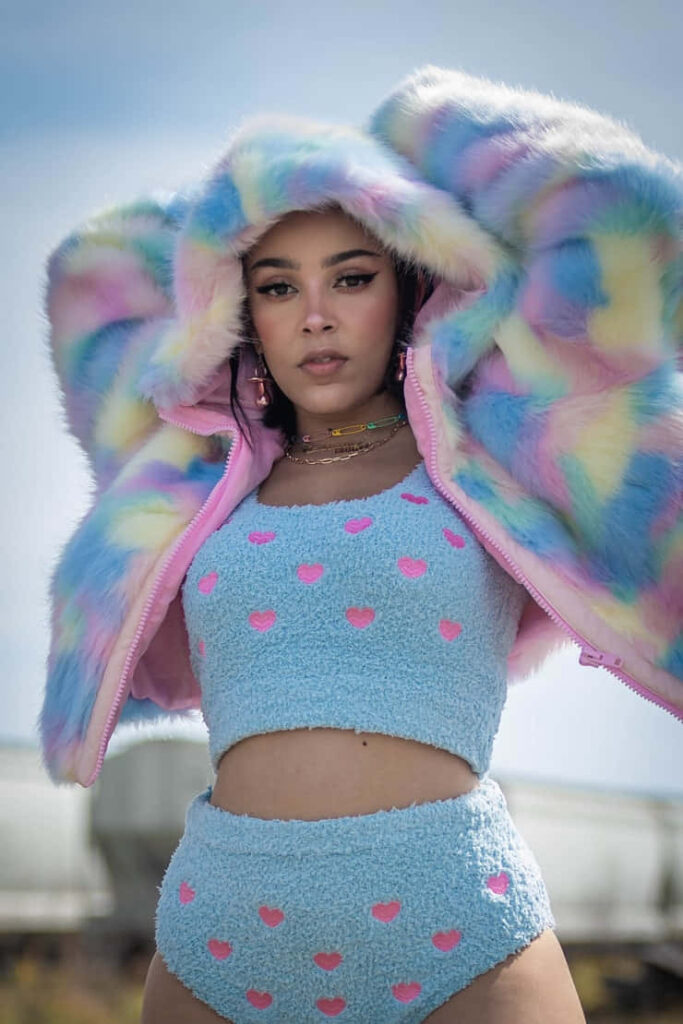 Playful Doja Cat Wallpaper: Pastel Fur Coat & Heart Details Background