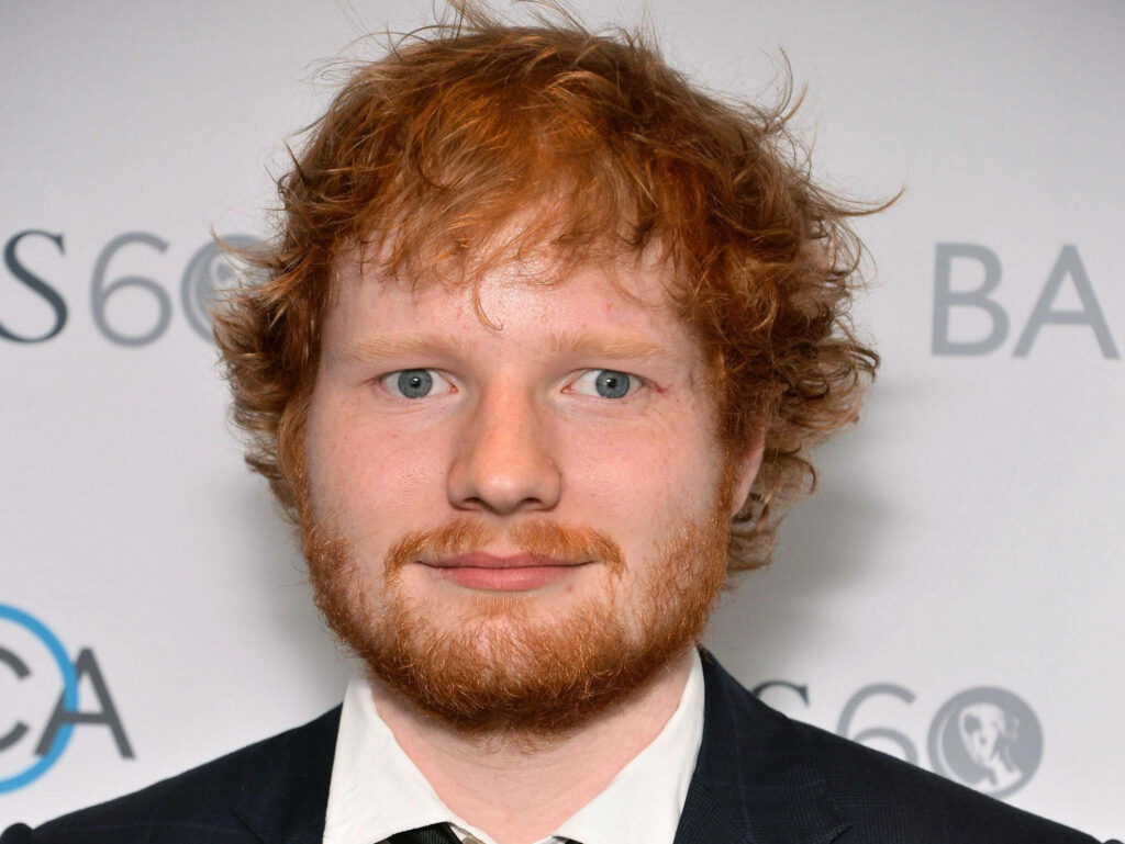 Ed Sheeran's Elegant Red Carpet Charm - Captivating Wallpaper Background