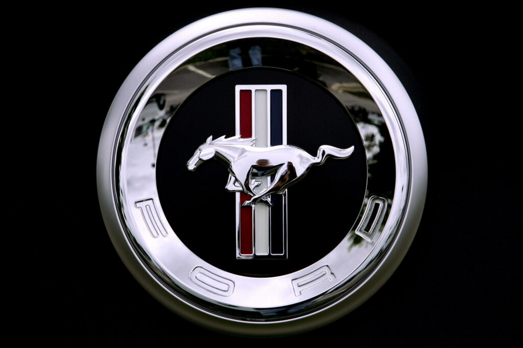 Ford Mustang Logo Wallpaper: Galloping Horse on Black Background