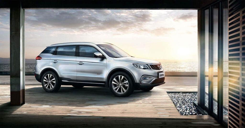 Stylish Geely Sedan Wallpaper: Sunrise Serenity on a Wooden Deck