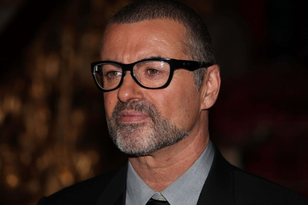 George Michael Portrait in Glasses: Composed Expression Wallpaper