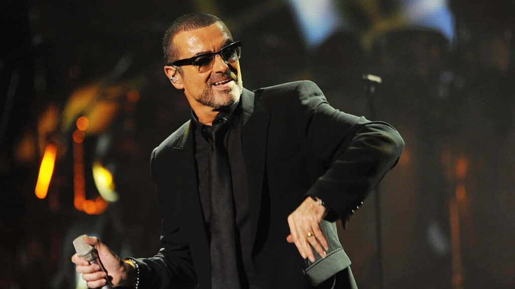 Stylish George Michael Wallpaper: Charismatic Stage Performance
