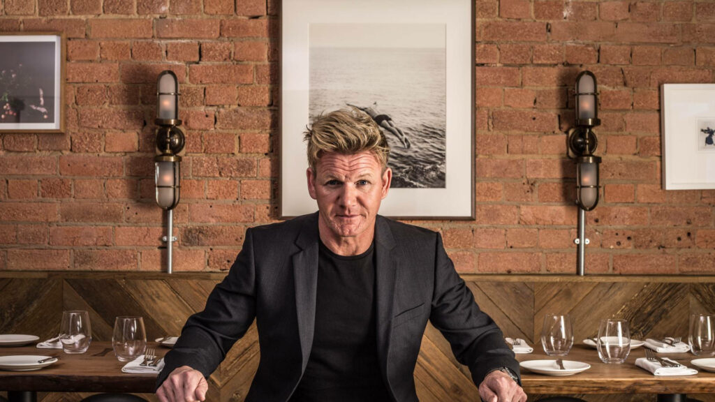 Elegant Wallpaper of Gordon Ramsay in a Chic Restaurant Setting