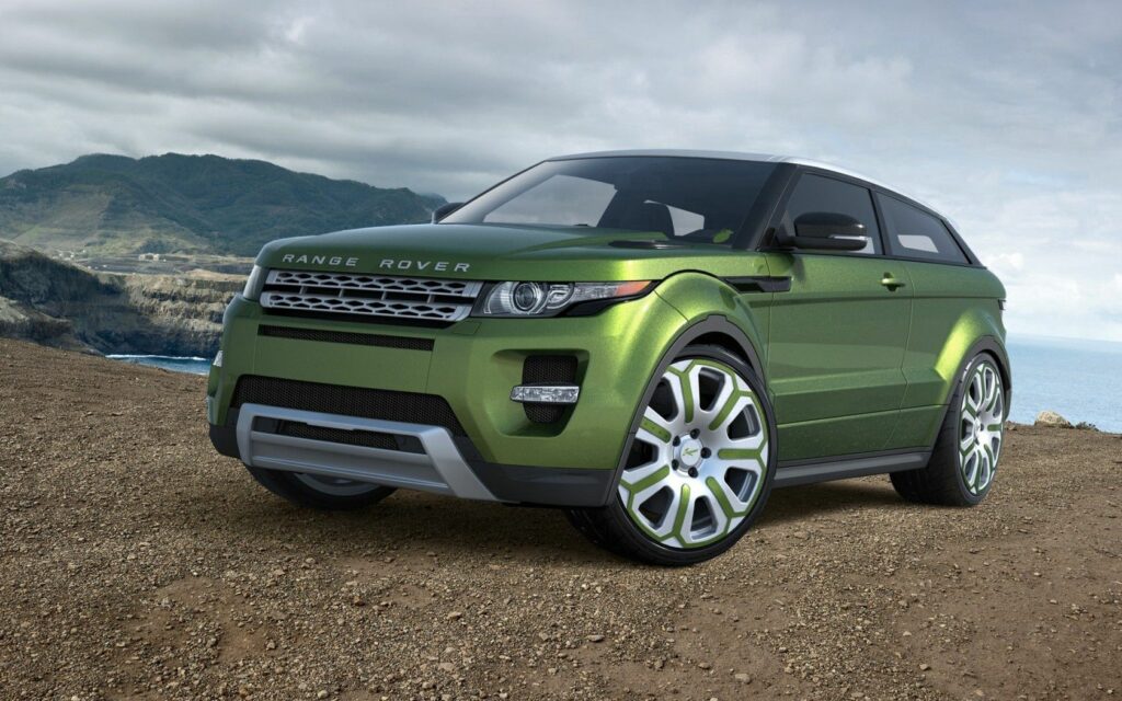 Sleek Green Range Rover Evoque Wallpaper in Rugged Outdoor Setting