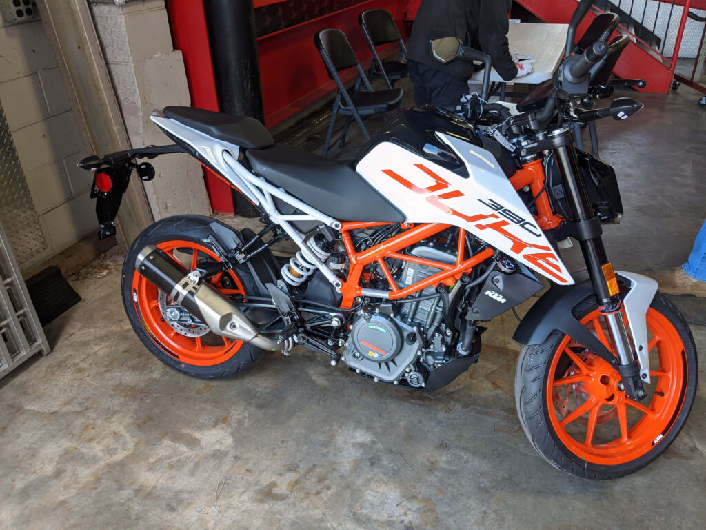 Sleek KTM Duke 390: Bold Orange Design in Garage Wallpaper