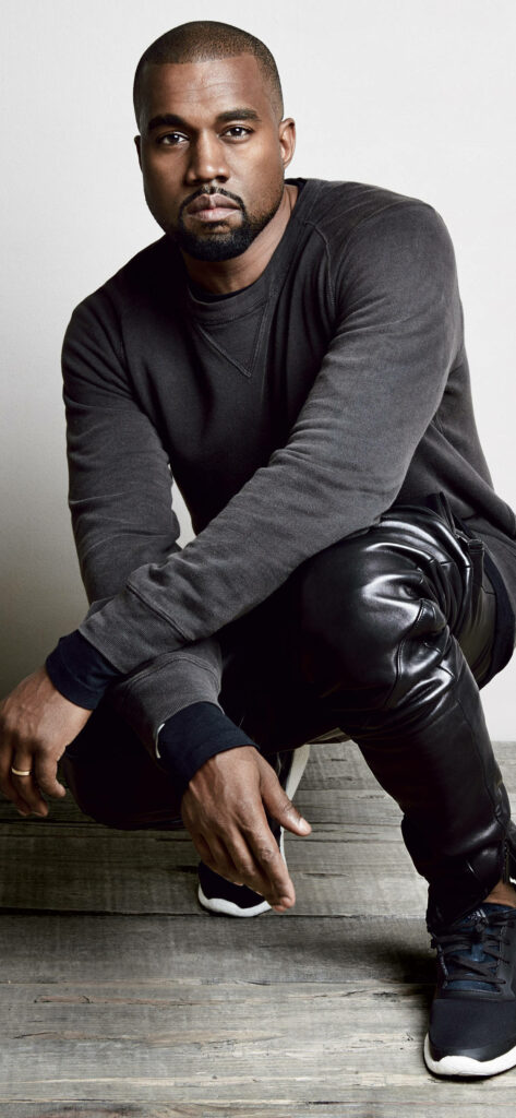 Minimalist Wallpaper: Kanye West Crouched in Dark Sweatshirt & Leather