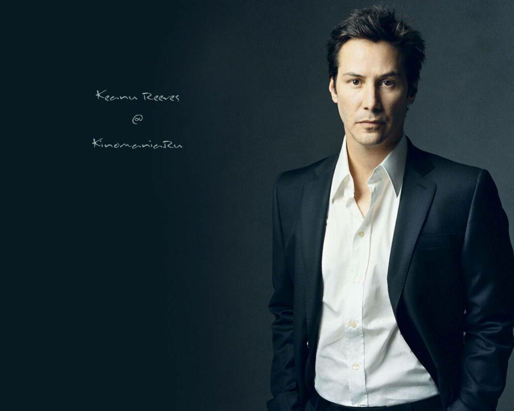 Elegant Keanu Reeves Wallpaper: Stylish Black Suit & Dark Background