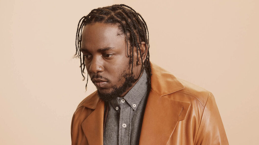 Kendrick Lamar Stylish Wallpaper: Leather Jacket on Beige Background