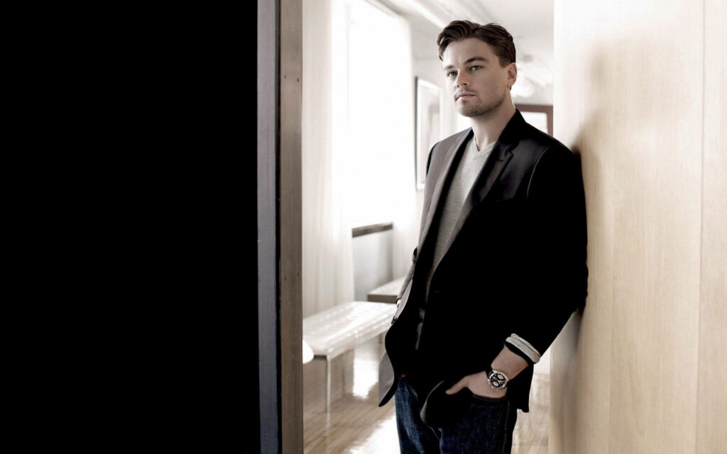 Elegant Leonardo DiCaprio Wallpaper: Stylish Charm in Minimalist Setting