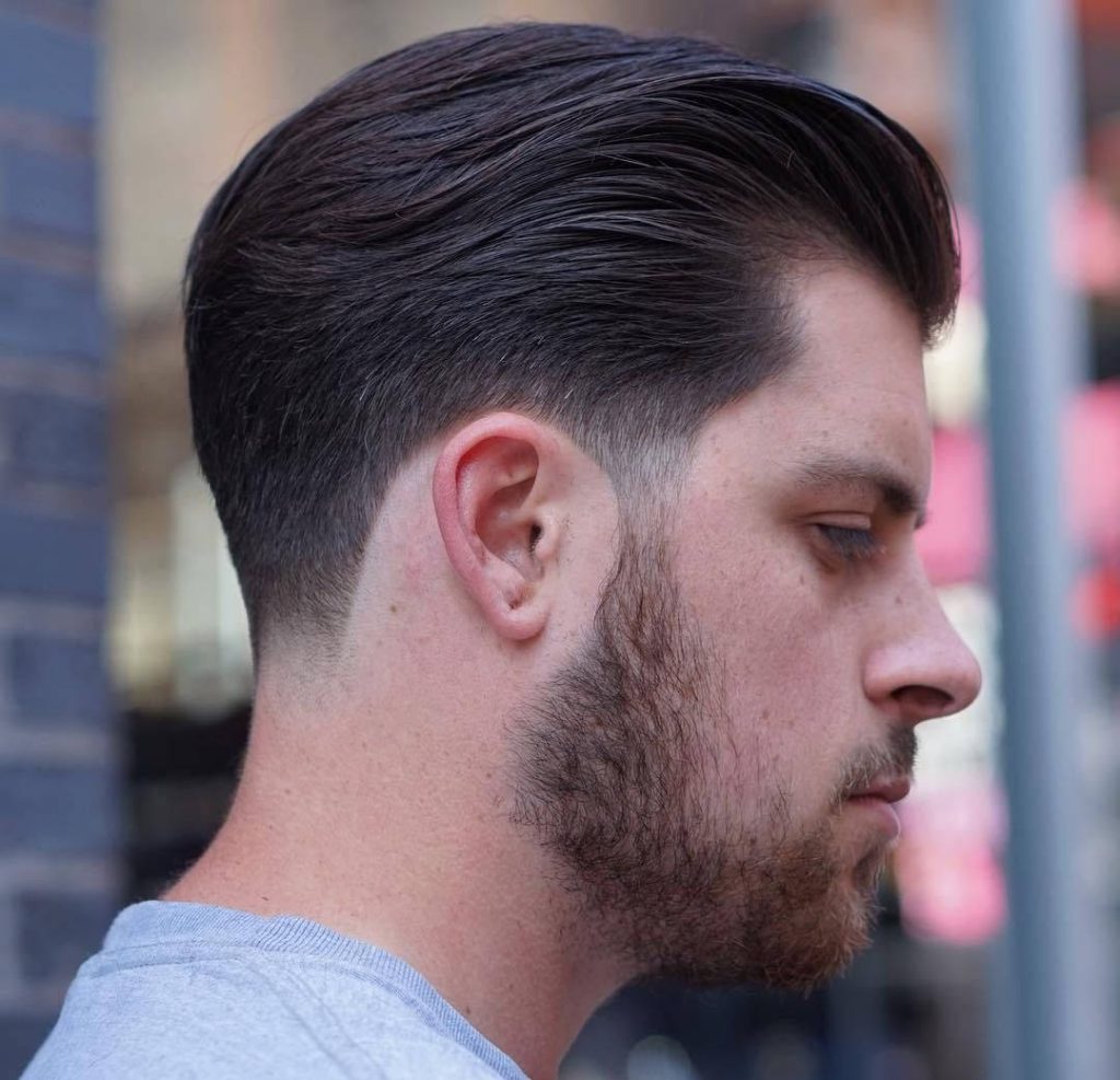 Men's taper fade haircut with slicked-back dark hair in high-definition stylish profile view Wallpaper