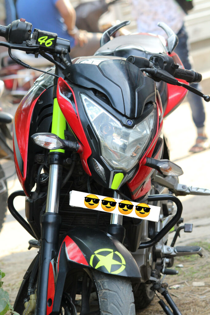 Vibrant NS 200 Motorcycle Wallpaper with Sunglasses Emoji Fun