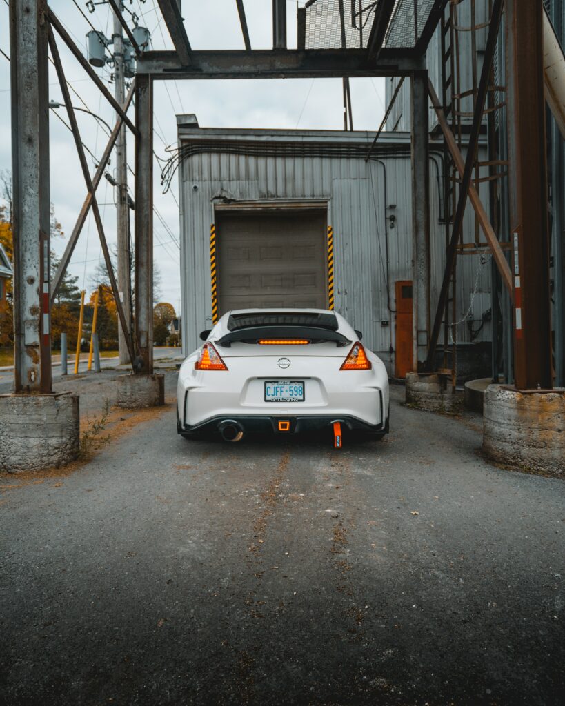 Sleek Nissan Sports Car Wallpaper: Rear View in Industrial Garage