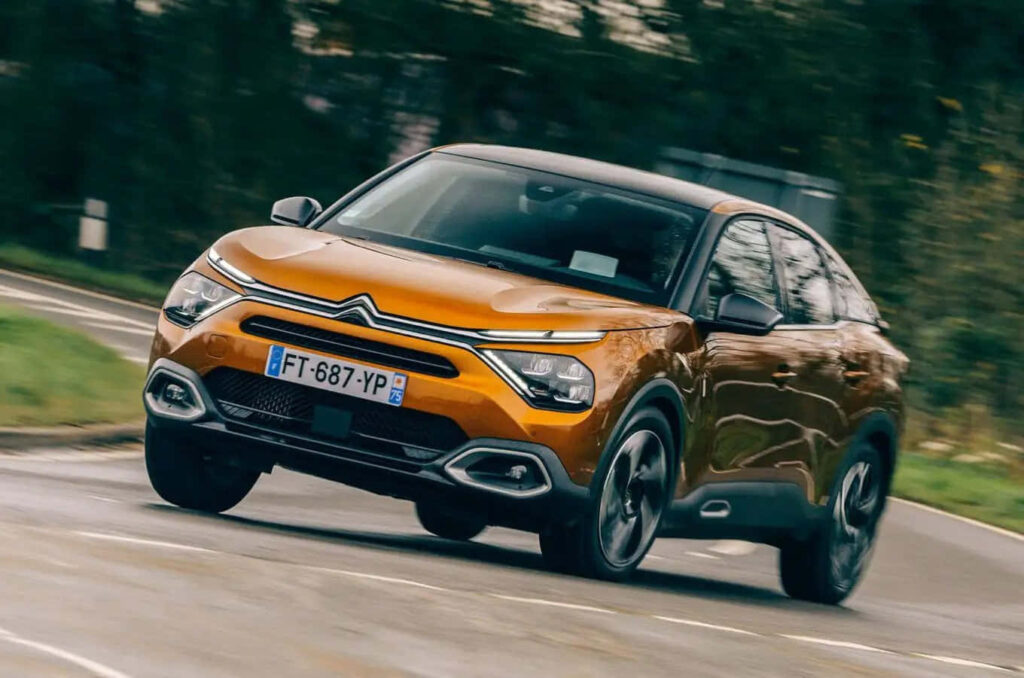 Stylish Orange Citroën Car in Motion - Dynamic Wallpaper Background