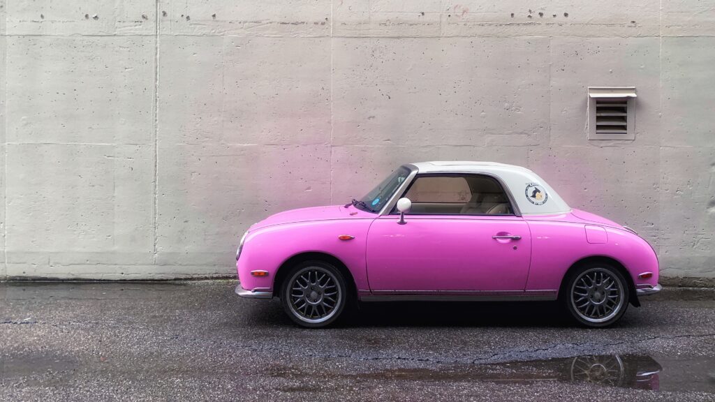 Stylish Pink Car Against Minimalist Concrete Wall - Modern Wallpaper