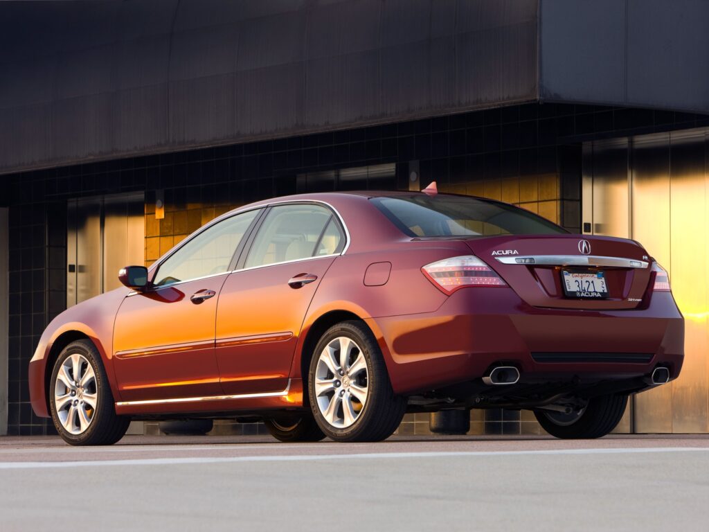 Sleek Red Acura RL Sedan Beside Modern Building Wallpaper
