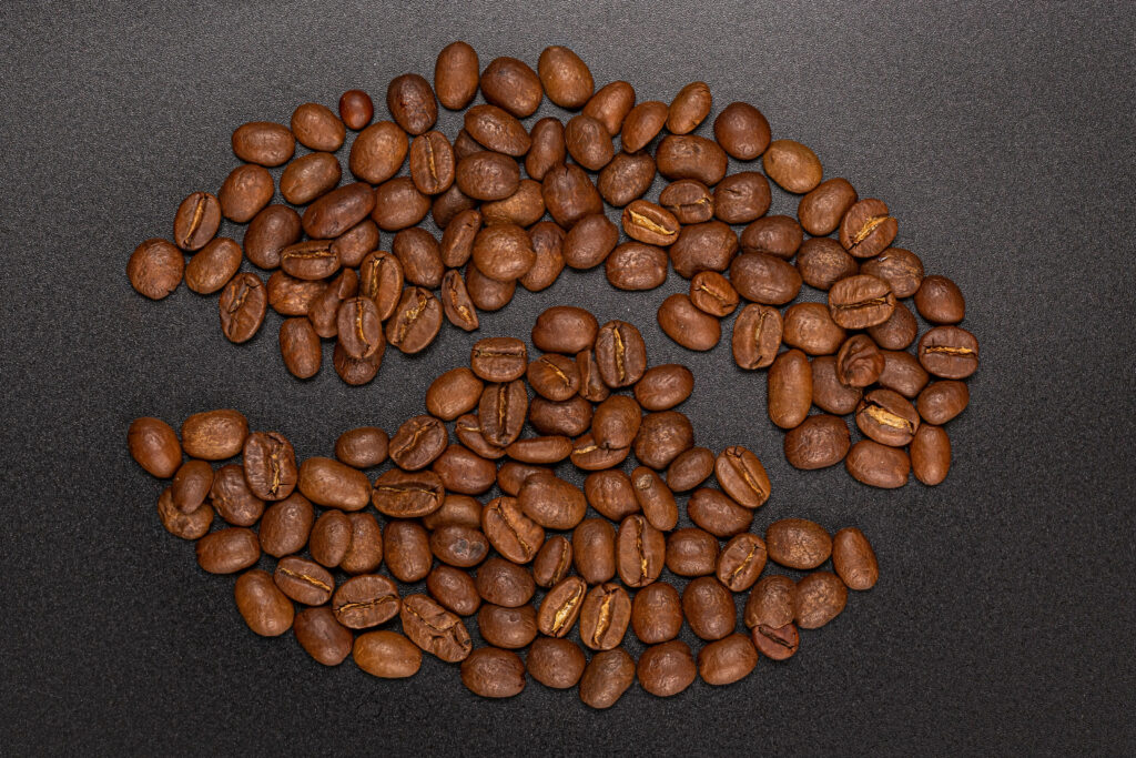 Stylish Roasted Coffee Beans Wallpaper on Dark Textured Background