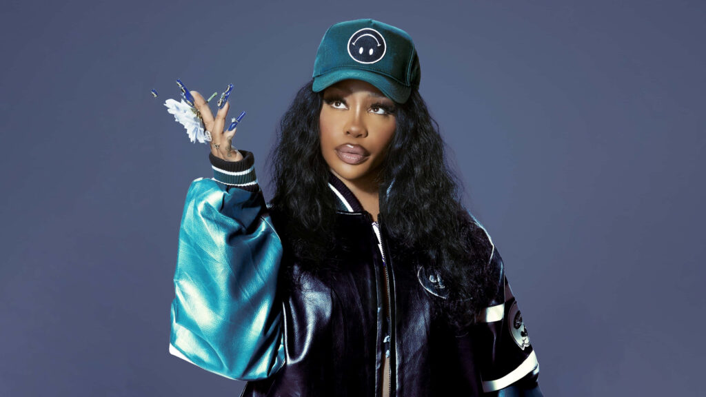 SZA Stylish Wallpaper: Blue Outfit & Charismatic Expression Background