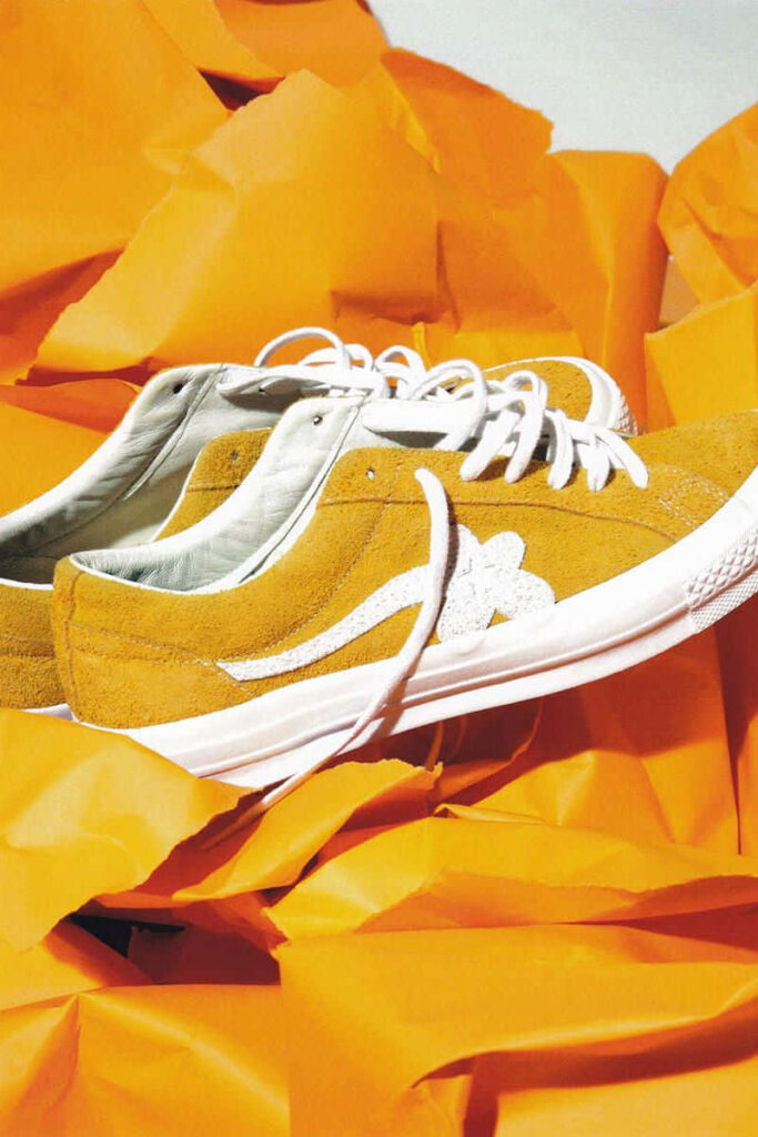 Stylish Yellow Shoes From Golf Le Fleur Add Flair on a Vibrant Backdrop Wallpaper