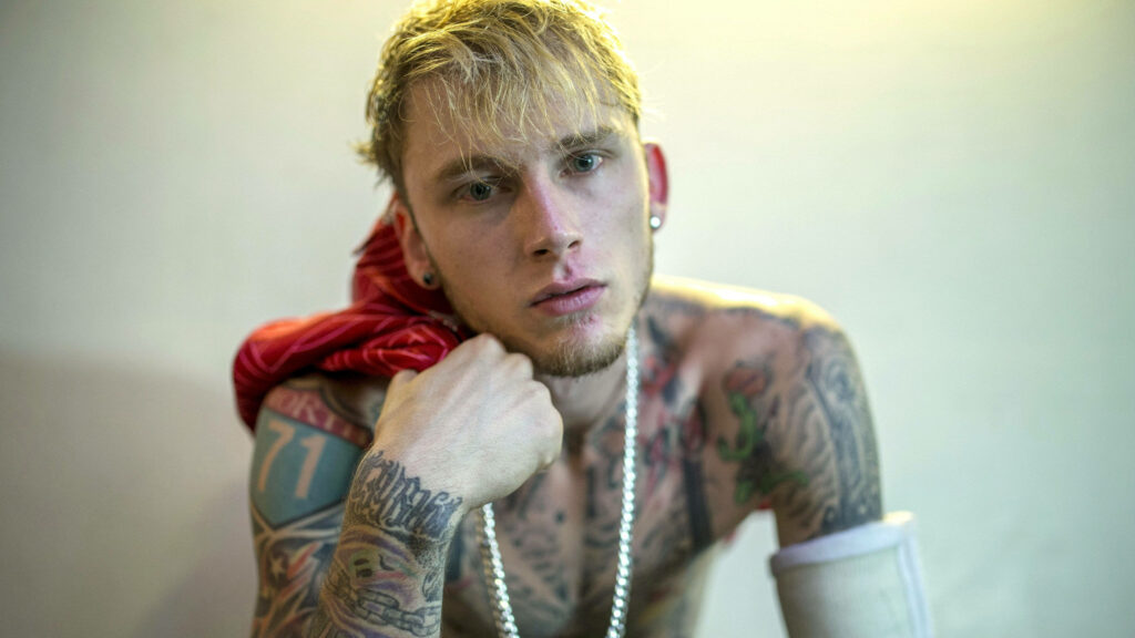 Edgy Machine Gun Kelly Wallpaper: Tattoos & Intense Gaze