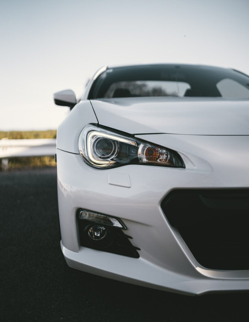 Stylish White Car Wallpaper: Front View & Distinctive Headlights