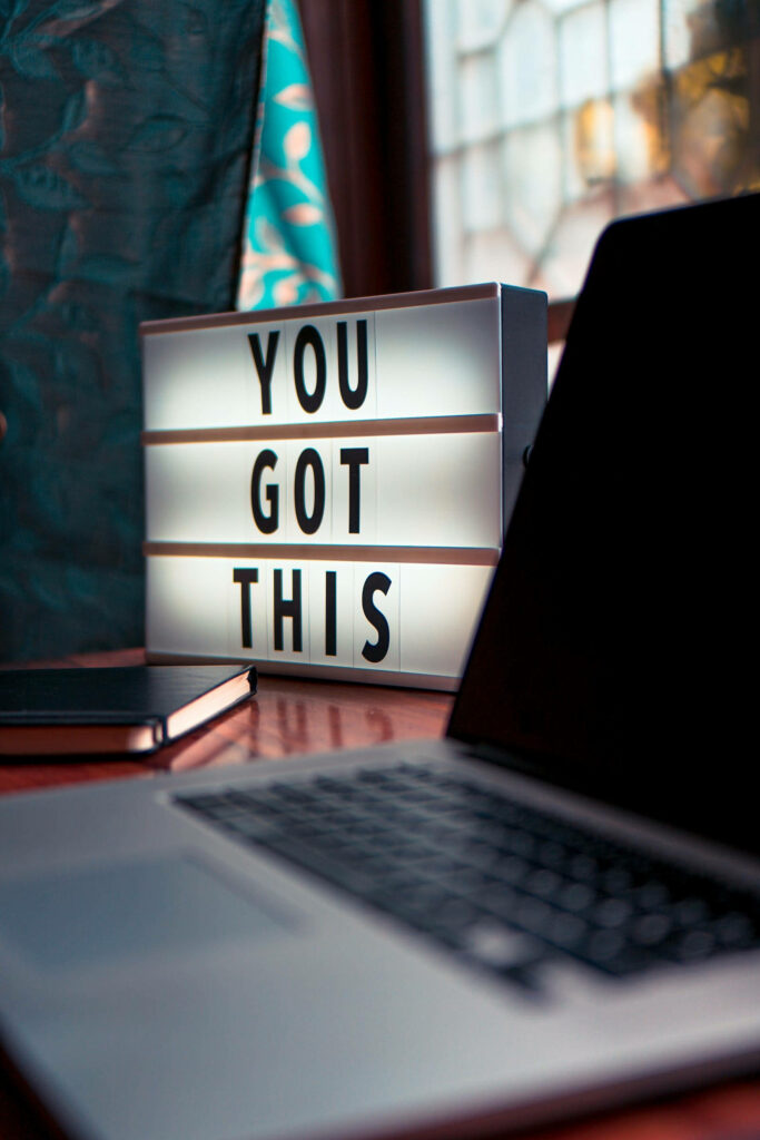 Stylish Workspace with Motivational Lightbox and Productivity Essentials Wallpaper