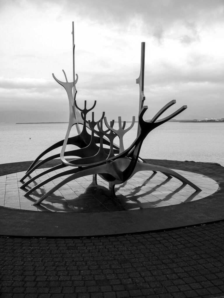 Metal Ship Sculpture Wallpaper: Artful Black & White Lake Scene